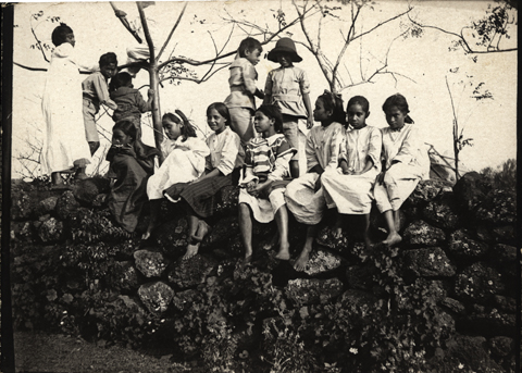 Native Easter Id Children on stone wall in the Colony