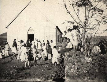 Native population in front of the Catholic Mission in the Colony