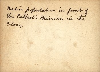 Back of photo: Native population in front of the Catholic Mission in the Colony